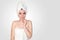 Close Up Beautiful Young Woman in White Towel on Head After Shower on Light Background. Spa Concept