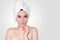 Close Up Beautiful Young Woman in White Towel on Head After Shower on Light Background. Spa Concept