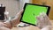 Close-up of beautiful young woman working in tablet with green screen. Stock footage. Female hands hold and hold on