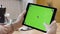 Close-up of beautiful young woman working in tablet with green screen. Stock footage. Female hands hold and hold on