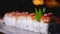 Close-up of beautifully decorated sushi rolls on plate with wasabi. Frame. Professionally prepared and decorated sushi