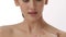 Close up beauty portrait of beautiful woman touching healthy skin and bare shoulders in slow motion