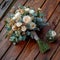 Close up beauty rustic wedding bouquet with creamy roses and carnations