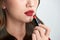 Close up of beauty skincare woman take lipstick on the white background