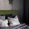 Close-up on bed with green velour headboard