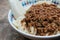 Close up Beef noodles chili sauce served in a bowl on table. Soup beef noodle in a bowl on wooden table. Chinese taiwanese cuisine