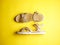 Close up of beige leather summer comfortable women`s sandals on brigth yellow background. Top view, side view, flat lay