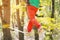 Close-up below the waist of a sporty man practicing slackline balance in autumn forest
