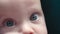 close-up big blue green eyes of caucasian baby infant child look camera