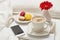 Close-up of big cup of cappuccino with macaroons and phone