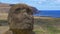 CLOSE UP: Big moai statue decaying in the scenic tropical wilderness of Chile