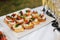Close-up big plate with serving snack canapes fried bread tomato parsley and salami