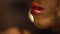 Close-up of big red lips of african american female model. Stylist prepares model for the fashion shooting. Vogue