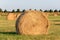 Close up of a big roll of harvested hay  lying on farmland