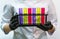 Close-up of a biologist girl in a White lab coat holding colorful flasks for experiments. Female doctor`s Hands in black rubber gl