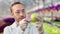 Close-up biologist scientist injecting ripe apple using syringe making testing genetically modified