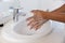 Close up of biracial man washing hands in bathroom at home