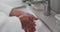 Close up of biracial woman washing hands in bathroom, slow motion