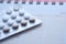 Close up of birth control pills and calendar on table