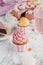 close up of birthday cupcakes pink cake and milkshake in glass on marble