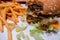 Close up of a bitten double cheeseburger on a tray