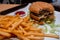 Close up of a bitten double cheeseburger on a tray