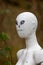 Close up of bizarre head and face of female white mannequin in woodland setting at Marston Park, Somerset, UK