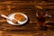 Close up. Black aromatic tea in a glass transparent cup. White plate with gold honey on a Rustic brown wooden table