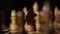 Close up of black chess piece on board. Wooden figure of knight on chessboard on black background. Concept of