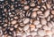 Close up of Black coffee beans with a natural bitter taste, with blurry background