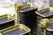Close up of black containers with gold-plated lids