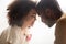 Close up of black dad and daughter touch foreheads