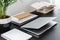 Close-up on black desk with plant, books and laptop in modern freelancer`s interior