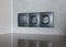 A close-up on black European socket, power outlet plug and light switch on a gray wall in the kitchen