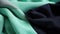 a close up of a black and green fabric with a white stripe