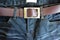 Close up black jeans trouser and brown leather belt.