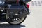 Close up of a black leather strapped and studded motorcycle pannier or bag, on a sunny day