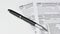Close-up of a black pen placed on a 1040 US personal income tax form