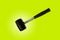 Close up black rubber mallet isolated on bright green background. Rubber hammer is a construction tool. Clipping path