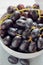 Close up black seedless grapes in a white ceramic bowl