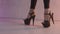 Close up for black shoes for pole dance with high heels on legs of a woman-dancer, modern dance concept. Action. A woman