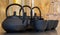 Close up of black textured cast iron Asian style tea pots with handles and matching cups.