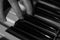 Close-up black and white atmospheric photo of fingers playing piano. keys. Concept: Music creating, composing, lyrics
