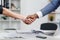 Close-up of a black and white hands shaking over a good business agreement.