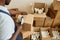 Close up of black young man taping boxes at factory or shipping services