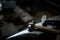 Close-up of a blacksmith`s hands manipulating a metal piece above his forge, selective focus.