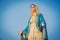 Close-up of the blessed Virgin Mary statue figure. Catholic praying for our lady - The Virgin Mary. Blue sky copy space on