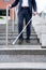 Close Up Of Blind Person Negotiating Steps Outdoors Using Cane