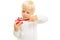 Close-up of a blond male child with a toy in the form of a tooth jaw and a white toothbrush on a white background