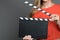 Close up a blond woman holding a clapperboard